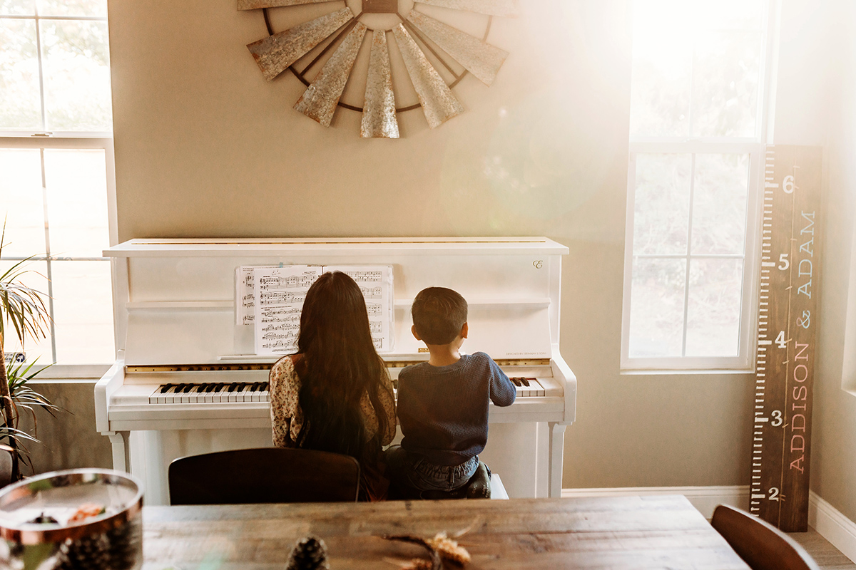 brother and sister playing piano at home in Fort Collins