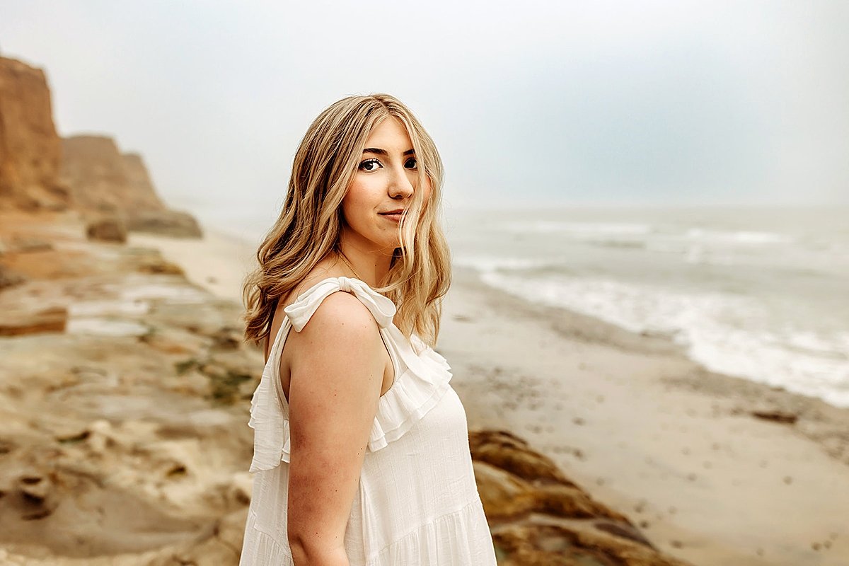  breezy day on the beach with high school girl for cliffside portrait session 