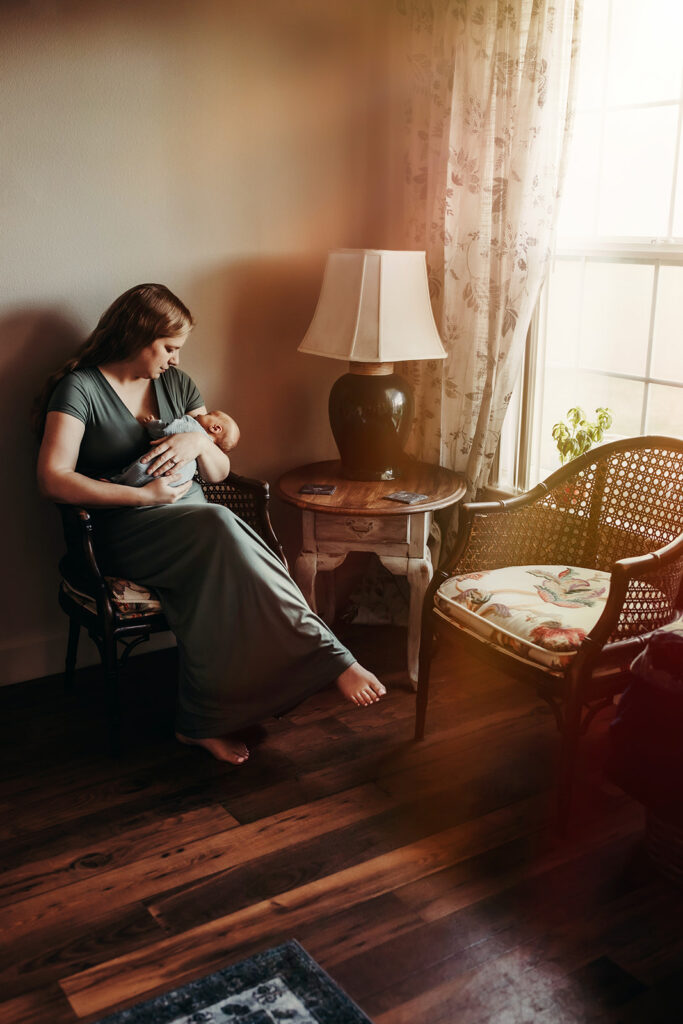 New mom rocking her newborn son in the afternoon light.