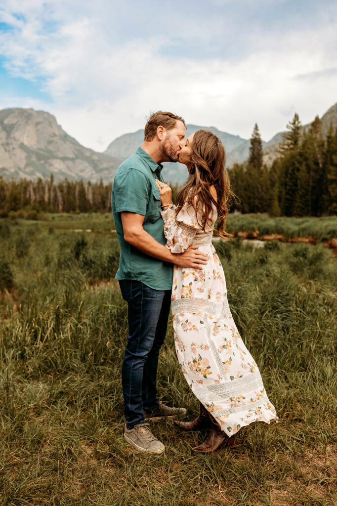 Husband and wife kissing and embracing in Rocky Mountain National Park