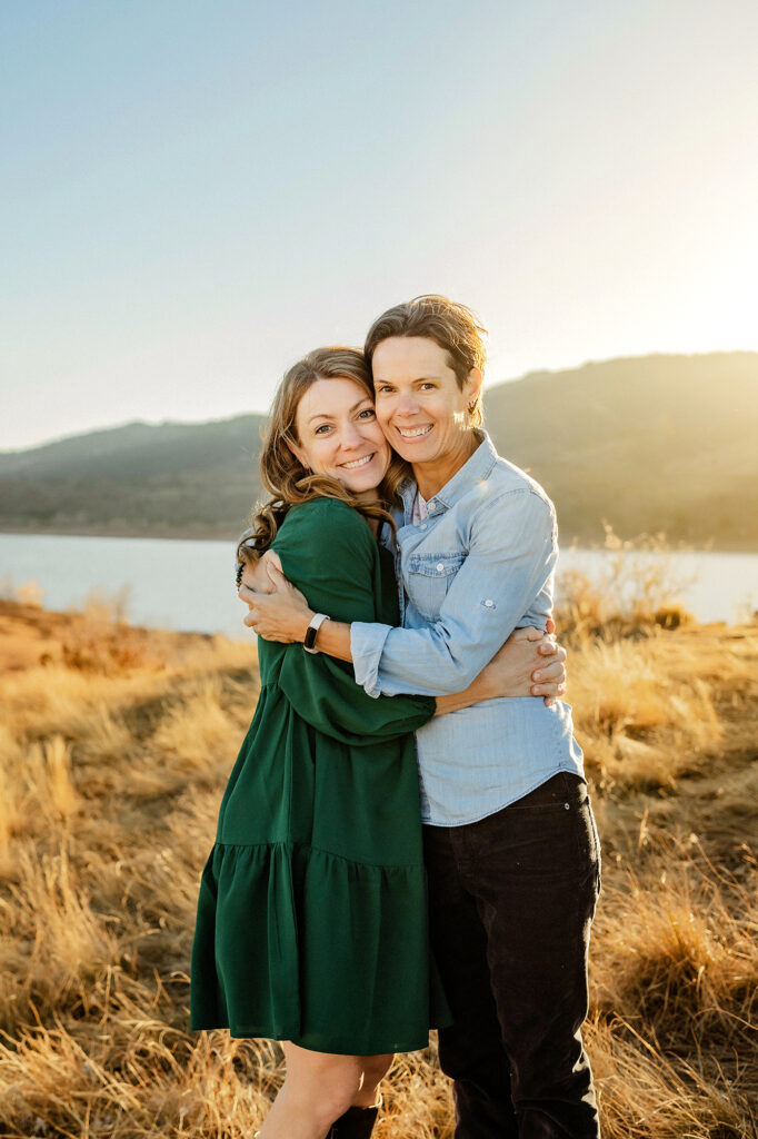 Wives hugging during their family session at Horsetooth Reservoir. 