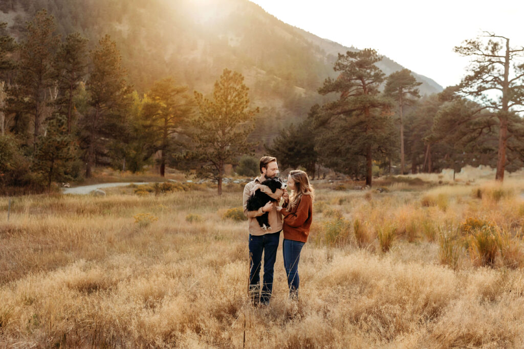 Husband, wife and new puppy snuggling together at sunset in Loveland, Colorado. 