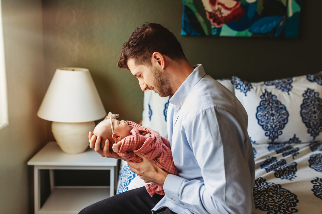 New dad holding his newborn daughter in Fort Collins