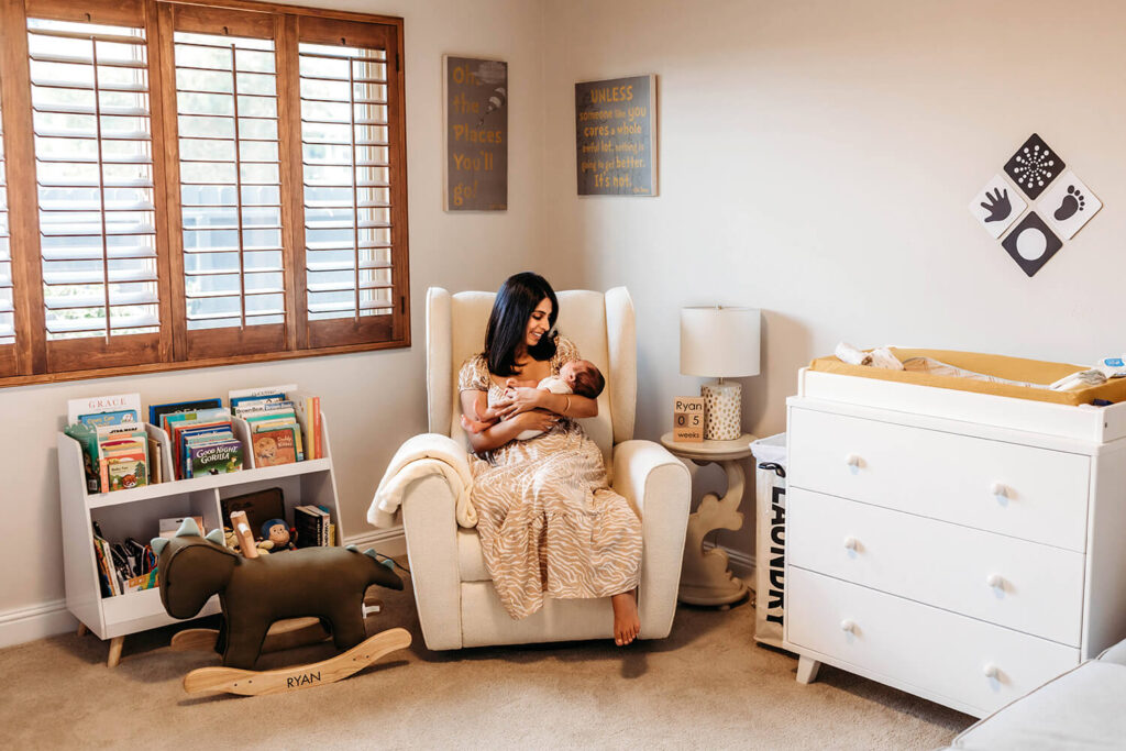 New mom rocking her newborn son in his room in the afternoon. 